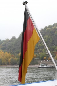 A picture of the German flag with a lake in the background