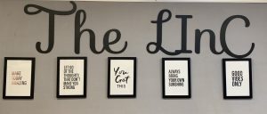 A photo of a wall with "The Linc" wrote on it. Below are several motivational quotes